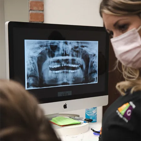 Dental x-rays being discussed between a practitioner and patient